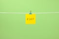 Yellow paper note on the string with text Ã¢â¬ÅASAPÃ¢â¬Â Royalty Free Stock Photo